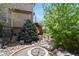 Landscaped backyard area featuring a charming firepit and pathway leading to the deck at 9536 W Avalon Dr, Littleton, CO 80127