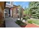 Charming front entrance with stone accents, a wreath, and manicured landscaping creating inviting curb appeal at 9536 W Avalon Dr, Littleton, CO 80127