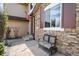 Welcoming front porch with stone accents, a bench, and manicured landscaping creating inviting curb appeal at 9536 W Avalon Dr, Littleton, CO 80127