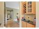 Elegant hallway with a wine rack, granite countertop, and access to the stairs at 9536 W Avalon Dr, Littleton, CO 80127