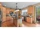 Well-equipped kitchen featuring stainless steel appliances, a central island, and ample counter space at 9536 W Avalon Dr, Littleton, CO 80127