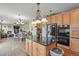 Open-concept kitchen with stainless steel appliances, granite countertops, and island seating at 9536 W Avalon Dr, Littleton, CO 80127