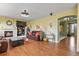 Inviting living room with a fireplace, hardwood floors, and a seamless transition to the kitchen at 9536 W Avalon Dr, Littleton, CO 80127