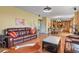 Spacious living room featuring a comfortable leather sofa, hardwood floors, and an open layout at 9536 W Avalon Dr, Littleton, CO 80127