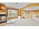 Living room features a fireplace, large windows and plush carpet at 9536 W Avalon Dr, Littleton, CO 80127
