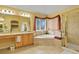 Main bathroom with a large soaking tub and glass shower at 9536 W Avalon Dr, Littleton, CO 80127