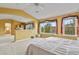 Spacious main bedroom includes a seating area and views of the fireplace and ensuite bathroom at 9536 W Avalon Dr, Littleton, CO 80127