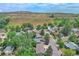Wide aerial shot of the neighborhood with lush trees and quaint homes at 1607 Ulysses St, Golden, CO 80401