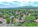 Expansive aerial view showcasing the community, lush greenery, and distant mountain views at 1607 Ulysses St, Golden, CO 80401