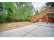 Spacious backyard with lush greenery and wooden stairs leading to the deck at 1607 Ulysses St, Golden, CO 80401