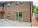 Backyard patio with brick home exterior, a sliding glass door, and walkway at 1607 Ulysses St, Golden, CO 80401