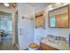 Bathroom featuring a wooden vanity and cabinet, toilet, and shower at 1607 Ulysses St, Golden, CO 80401