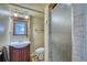 Bathroom featuring a vanity with a sink, toilet, and glass-enclosed shower at 1607 Ulysses St, Golden, CO 80401