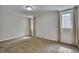 Bright bedroom featuring neutral walls, carpet, and light-filled windows at 1607 Ulysses St, Golden, CO 80401
