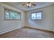 Bright bedroom with two windows, neutral carpet, and neutral paint at 1607 Ulysses St, Golden, CO 80401