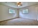 Bright bedroom with two windows, neutral carpet, and neutral paint at 1607 Ulysses St, Golden, CO 80401