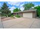 Brick home featuring a spacious driveway leading to a two-car garage at 1607 Ulysses St, Golden, CO 80401