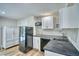 Well-lit kitchen featuring modern appliances, white cabinetry, and an island at 1607 Ulysses St, Golden, CO 80401