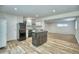 Cozy kitchen with white cabinetry, modern appliances, and center island at 1607 Ulysses St, Golden, CO 80401