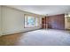 Spacious living room with a brick accent wall and a large bay window at 1607 Ulysses St, Golden, CO 80401
