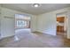 Open living space leading to the dining area and kitchen, carpet flooring at 1607 Ulysses St, Golden, CO 80401