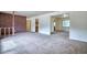Inviting living room with neutral carpet, brick accent wall, and ample space at 1607 Ulysses St, Golden, CO 80401