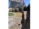 Backyard view featuring stone patio, artificial turf, low garden wall, and wood fence at 17910 E 54Th Ave, Denver, CO 80249