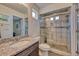 Bathroom featuring granite countertops, a glass-enclosed shower with decorative tile accents at 17910 E 54Th Ave, Denver, CO 80249