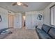 Versatile bedroom space featuring a comfortable sofa, closet space, and ensuite bathroom access at 17910 E 54Th Ave, Denver, CO 80249
