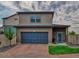 Charming two-story home featuring a brick driveway, a two-car garage, and a well-maintained lawn at 17910 E 54Th Ave, Denver, CO 80249
