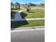 Expansive front lawn with lush grass, paved sidewalk, and young trees lining the street at 17910 E 54Th Ave, Denver, CO 80249