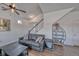 Inviting living room featuring a comfortable sofa, stylish decor, staircase, and wood look flooring at 17910 E 54Th Ave, Denver, CO 80249