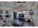 Cozy living room with wood-look flooring, ceiling fan and large windows filling the room with light at 17910 E 54Th Ave, Denver, CO 80249