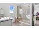 Bright bathroom featuring frameless shower, granite counters, and convenient bench seating for relaxing spa days at 8353 Bijou Creek Ave, Littleton, CO 80125