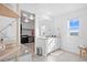 Bright bathroom featuring double vanity, granite counters, and spacious walk-in closet with custom shelving at 8353 Bijou Creek Ave, Littleton, CO 80125