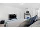 Inviting bedroom featuring large bed with plush pillows, media center, and standing desk for a relaxing retreat at 8353 Bijou Creek Ave, Littleton, CO 80125
