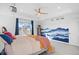 Large bedroom with painted mountain scene, tray ceiling, and a ceiling fan at 8353 Bijou Creek Ave, Littleton, CO 80125
