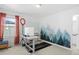 Versatile bedroom featuring a trendy accent wall, home office setup, and a full window letting in natural light at 8353 Bijou Creek Ave, Littleton, CO 80125
