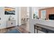 Welcoming entryway with hardwood floors, stylish decor, and a view into the light-filled living spaces at 8353 Bijou Creek Ave, Littleton, CO 80125