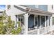 Inviting covered front porch featuring outdoor seating, stylish trim, and a cozy spot to relax and enjoy the outdoors at 8353 Bijou Creek Ave, Littleton, CO 80125