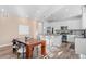 Bright eat-in kitchen featuring stainless steel appliances, granite countertops, and a large island with bar seating at 8353 Bijou Creek Ave, Littleton, CO 80125
