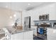 Bright kitchen featuring stainless steel appliances, center island, and white cabinets at 8353 Bijou Creek Ave, Littleton, CO 80125