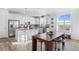 Eat-in kitchen featuring stainless steel appliances, granite countertops, and a large island for gathering at 8353 Bijou Creek Ave, Littleton, CO 80125