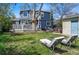 Two-story blue home with backyard featuring a deck, a hot tub area, a lawn and lounge chairs at 2244 Fenton St, Edgewater, CO 80214