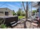 Backyard features a hot tub, stone patio, grassy area, and charming detached garage at 2244 Fenton St, Edgewater, CO 80214