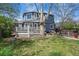 Two-story blue home with backyard featuring a deck, a hot tub area, and an adorable matching garage at 2244 Fenton St, Edgewater, CO 80214