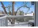 Charming balcony view featuring a snow-covered yard and a mature tree canopy at 2244 Fenton St, Edgewater, CO 80214