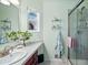 Well-lit bathroom with a glass-enclosed shower and marble countertops at 2244 Fenton St, Edgewater, CO 80214