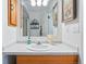 Bathroom vanity with marble countertop, undermount sink, decorative faucet, and a mirrored cabinet above at 2244 Fenton St, Edgewater, CO 80214