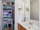 Well-organized bathroom featuring a vanity, round mirrors, and ample storage shelves at 2244 Fenton St, Edgewater, CO 80214